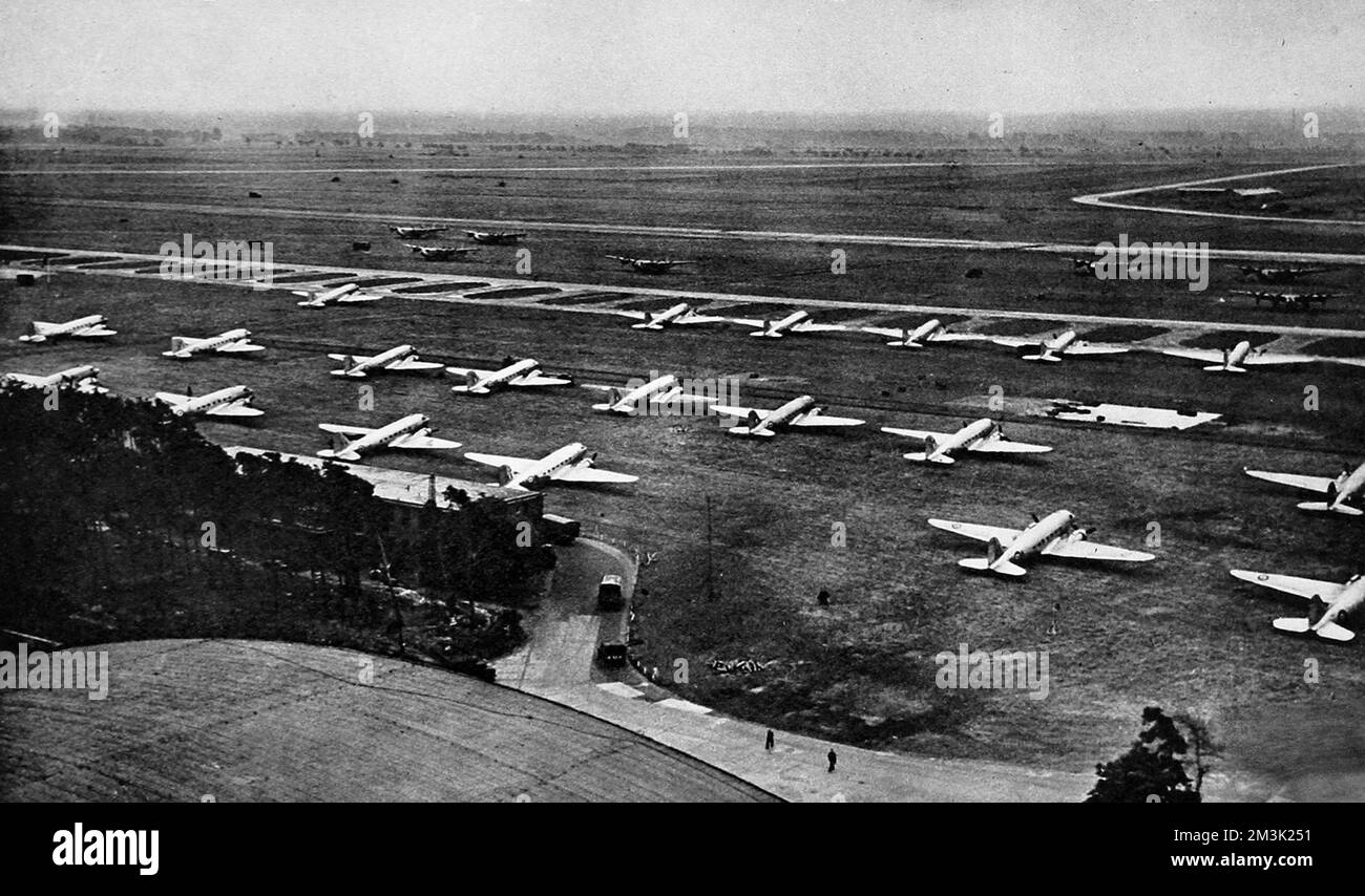 Photograph showing Wunstorf Airfield, near Hanover, in the British controlled zone of Germany, with a large number of 'Dakota' and 'York' airplanes lined up for use during the 'Berlin Airlift', 1948.    Between April 1948 and May 1949 Stalin, leader of the USSR, imposed a land blockade on supplies from Western Europe to West Berlin.  In response the British and American governments organised an enormous airlift to supply food and other essentials to the 2.5 million inhabitants of West Berlin.  After a year Stalin conceded defeat and lifted the land blockade.     Date: 1948 Stock Photo