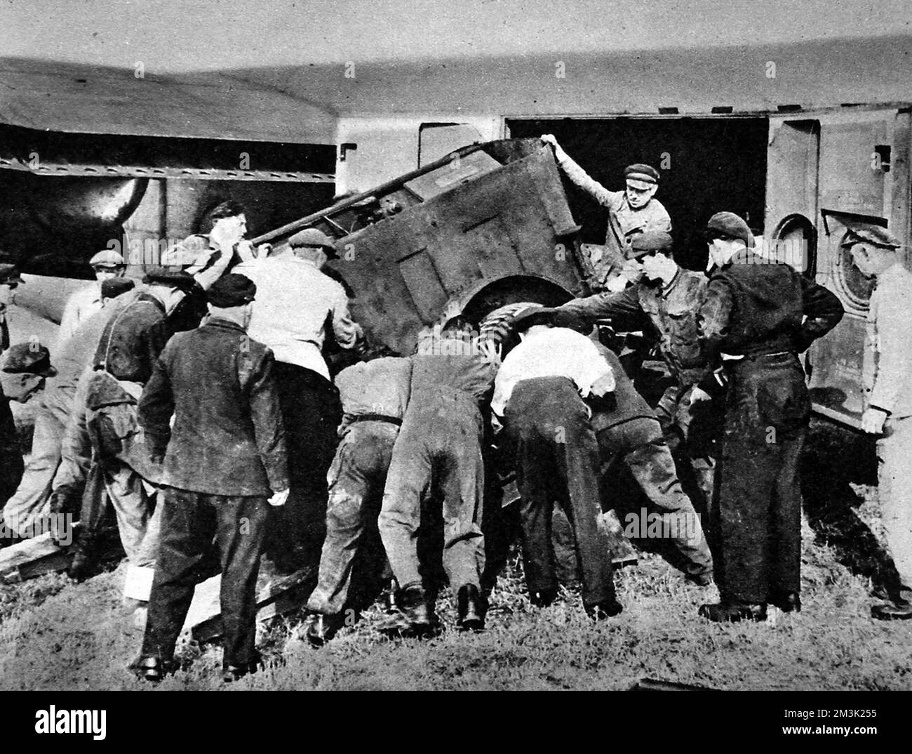 Photograph showing a generator set being unloaded from a 'York' aircraft at Gatow Airport, during the 'Berlin Airlift', 1948.    Between April 1948 and May 1949 Stalin, leader of the USSR, imposed a land blockade on supplies from Western Europe to West Berlin.  In response the British and American governments organised an enormous airlift to supply food and other essentials to the 2.5 million inhabitants of West Berlin.  After a year Stalin conceded defeat and lifted the land blockade.     Date: 1948 Stock Photo