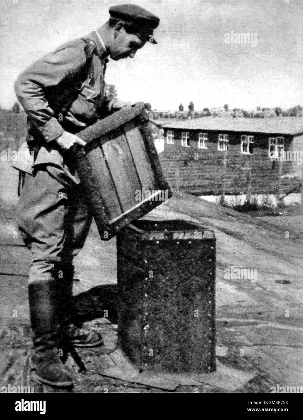 Photograph showing the opening in the roof of the gas chamber at Majdanek Concentration Camp, into which Zyklon-B crystals were poured, 1944.  In this picture a Soviet soldier can be seen holding the cover of the opening.    Majdanek, near Lublin in Poland, was run as a concentration camp by the Waffen-SS between 1941 and 1944.  Although the Germans attempted to destroy the evidence of their atrocities at the camp, there was too much to hide and the Russian army captured much of the camp intact.     Date: 1944 Stock Photo