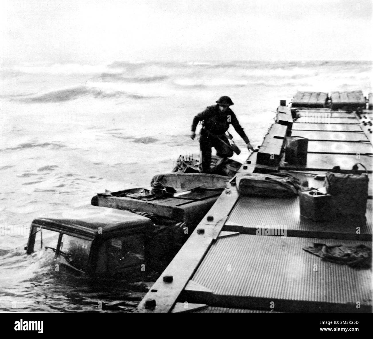 Photograph showing a three-ton truck sunk alongside a pontoon, during the Allied landings in the Nettuno-Anzio area, 1944.  The rough seas, visible in the background of this photograph, were a great problem to the Allied naval operations.     Date: 1944 Stock Photo