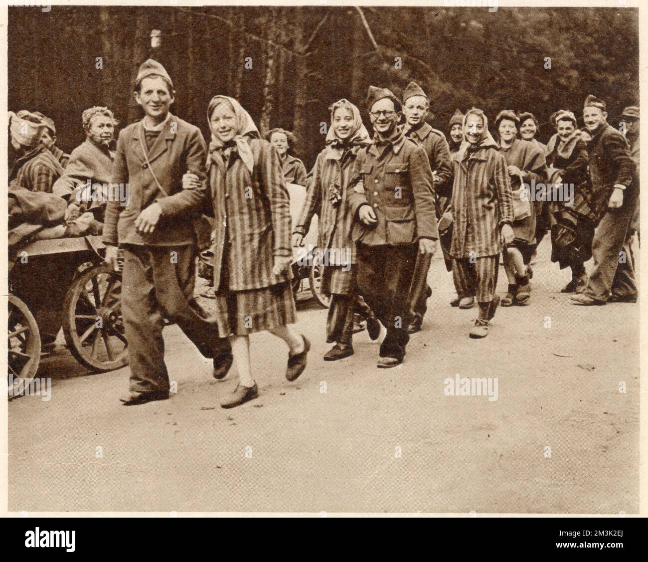 A group of French political prisoners, in striped prison garments, setting out from Berlin on the long journey home. At the end of the Second World War, many thousands of prisoners of the Nazi regime were freed and went home. Stock Photo