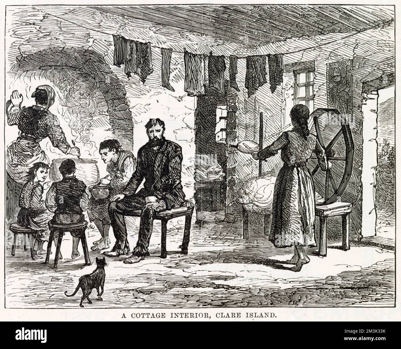 A family scene in a crowded and cramped cottage interior with laundry on a washing line and a cat included. A lady spins yarn near the door, another stirs a pot at the fireplace while the rest of the family sit near her. Miserable conditions were brought on by the potato famine in the mid 19th century in Clare Island, west of Ireland. Stock Photo
