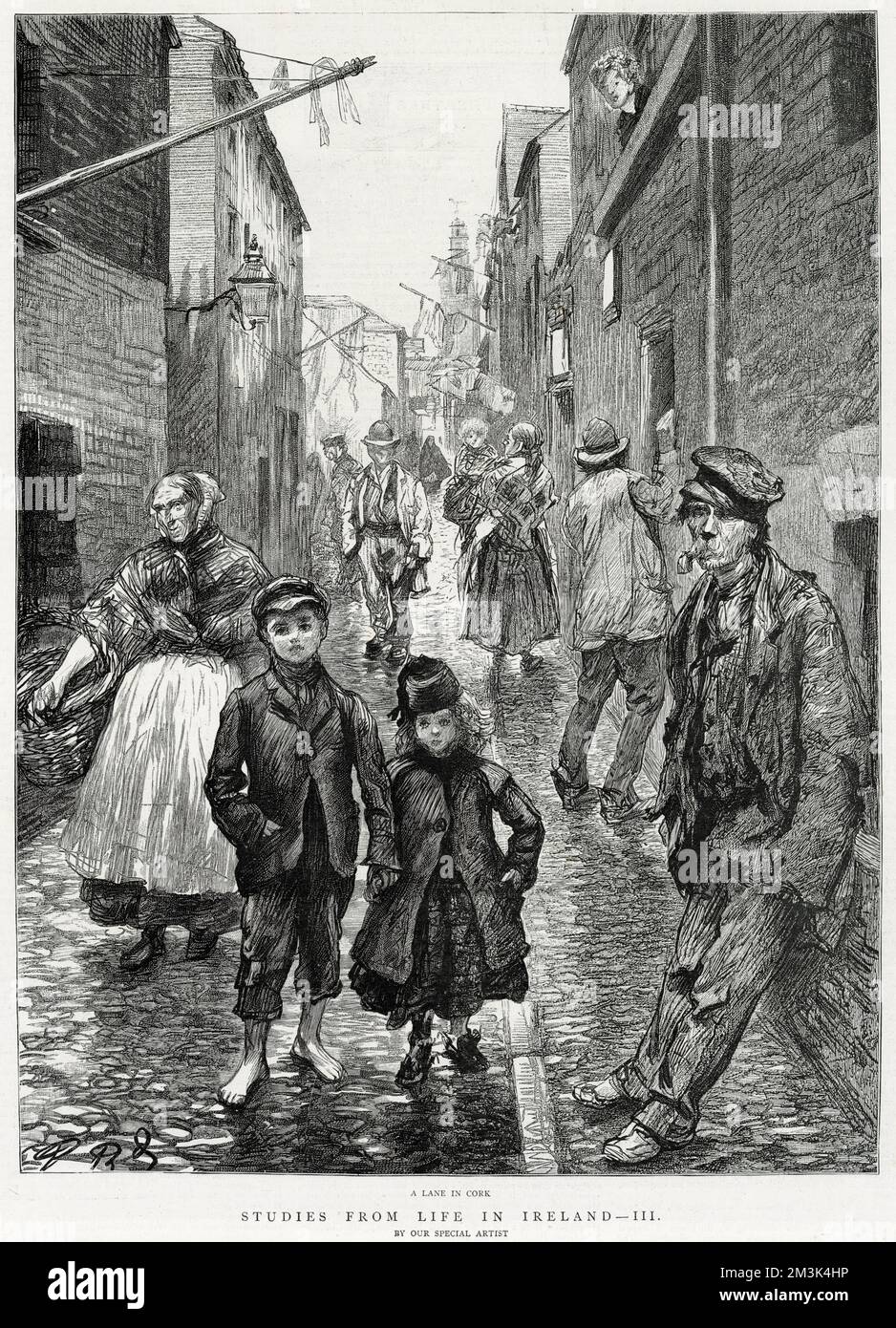 This is a general scene of street life in a lane in Cork, Ireland. In this poor neighbourhood men, women and children walk up and down the lane, washing hangs from one building and someone looks out of a window. Stock Photo