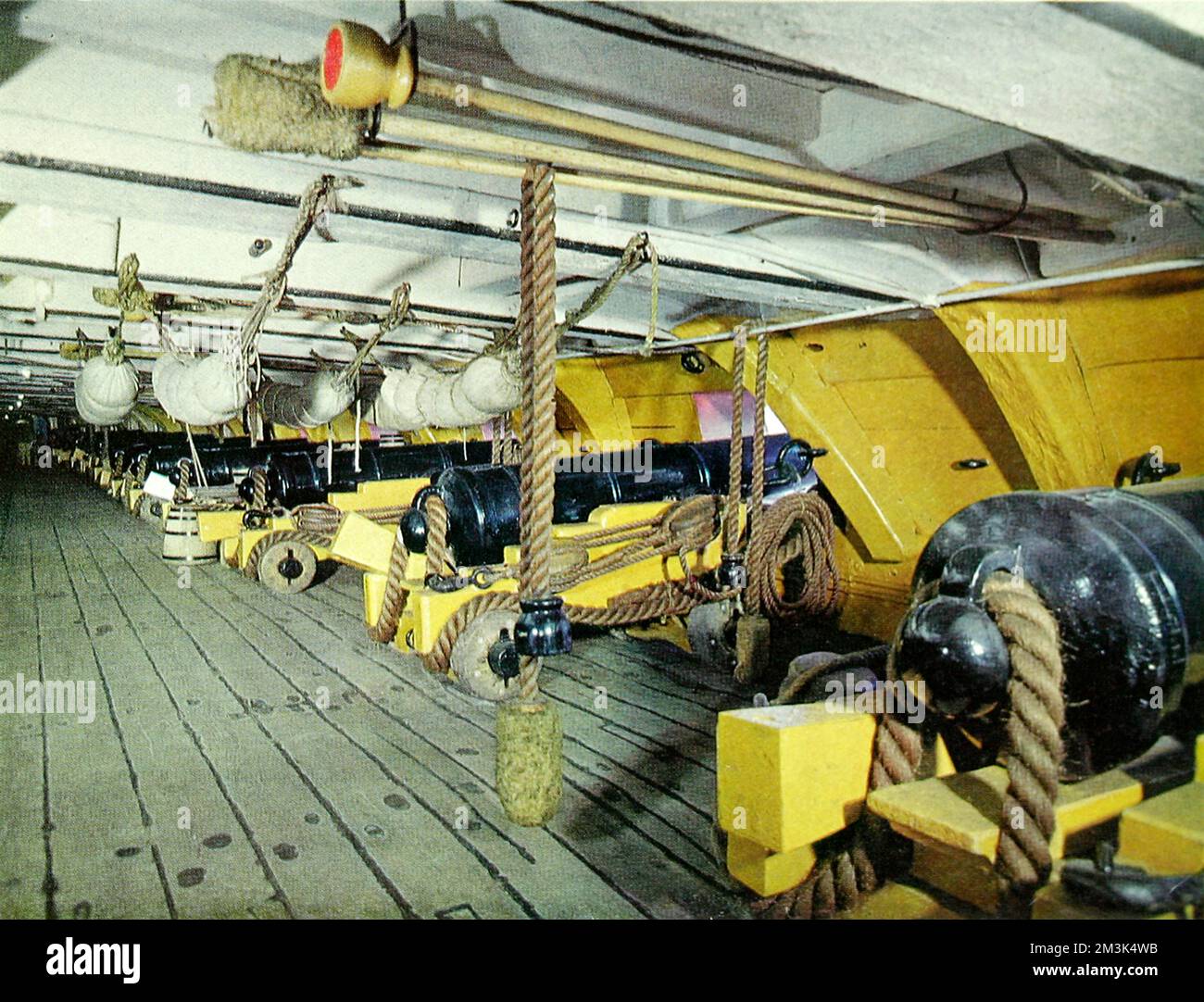 The interior of the famous H.M.S. Victory after extensive redecoration and restoration shown for the first time in colour.  This is the lower deck with canons called thirty-two pounders.  The rammers and sponges are above the guns and the crew's hammocks are slung and folded beside the battle stations.     Date: 19/10/1963 Stock Photo