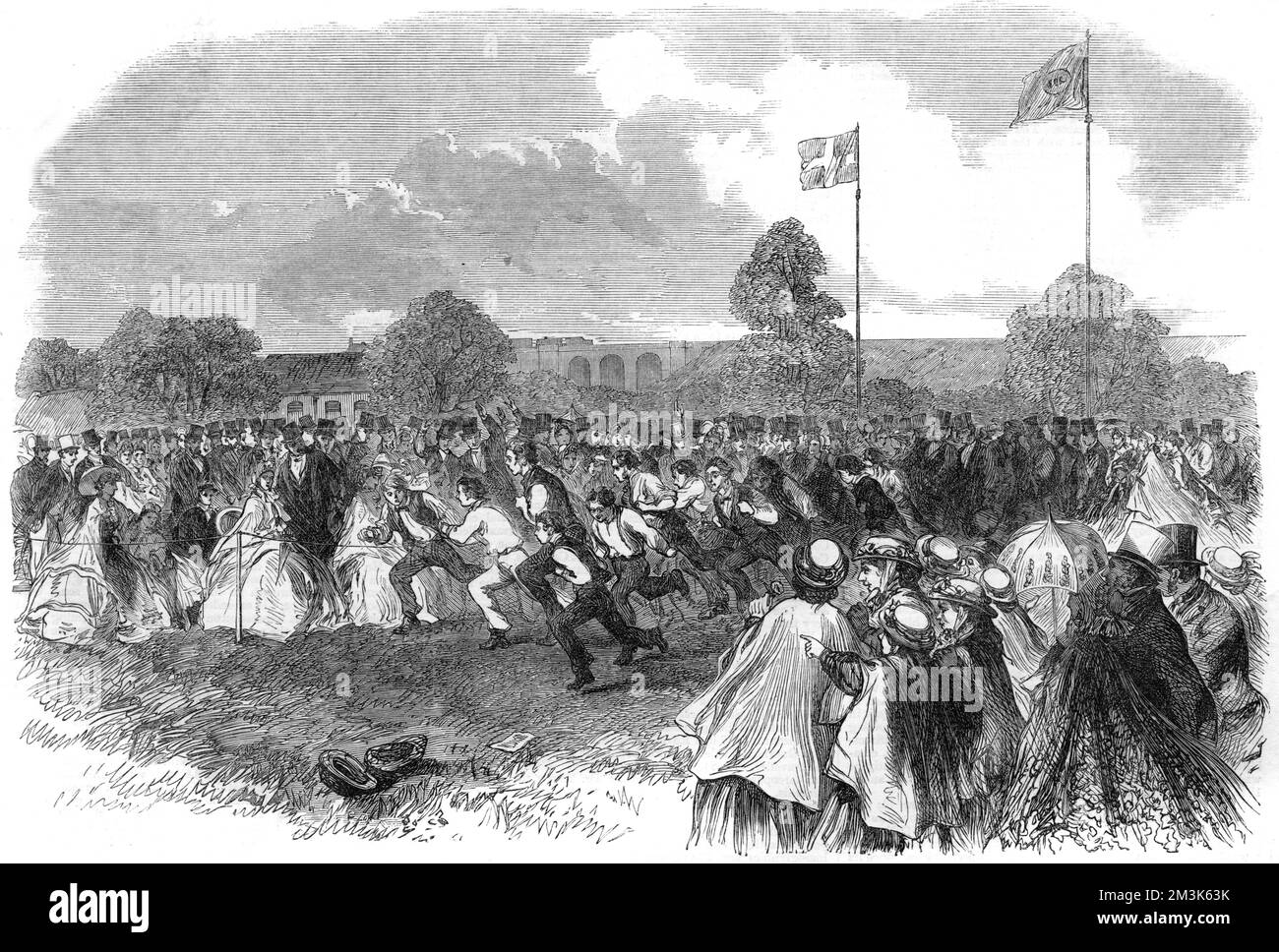 One of the running races held for the patients of the 'Earlswood Asylum for Idiots', near Redhill.  A large crowd of spectators, in Victorian dress, line the running track as the competitors sprint past.  1864 Stock Photo