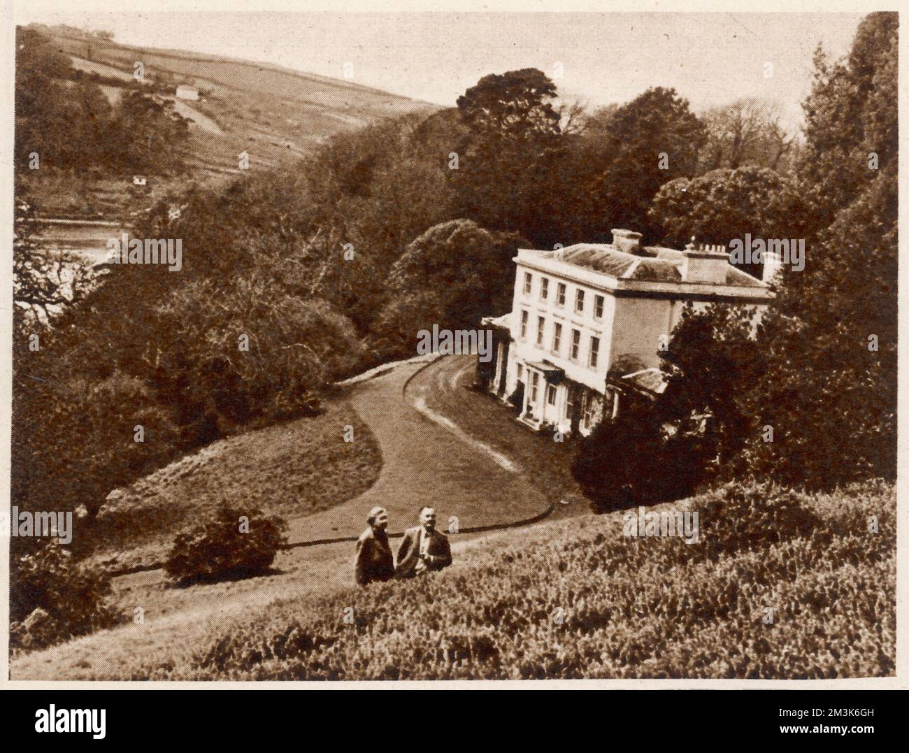Greenway House in Devon, which was the home of Agatha Christie and Max Mallowan. The couple can be seen (just) in the foreground of this image.  1946 Stock Photo