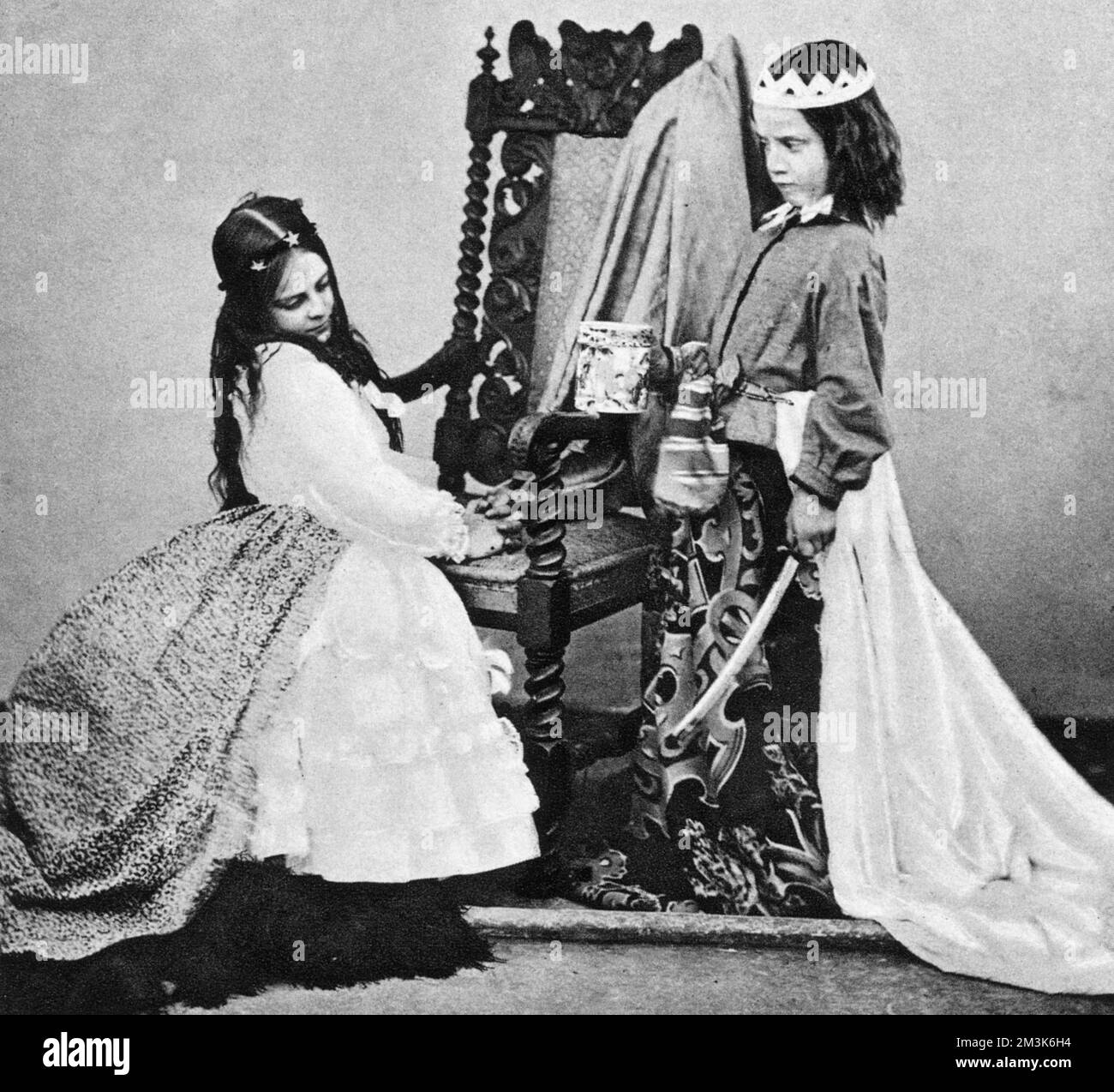 Lewis Carroll (Rev. Charles L. Dodgson) of 'Fair Rosamond', a fancy dress group, at Oxford in June 1863.   The children shown are Annie M. Rogers as 'Queen Eleanor' (on right) and Mary Jackson as 'Fair Rosamond'. Stock Photo