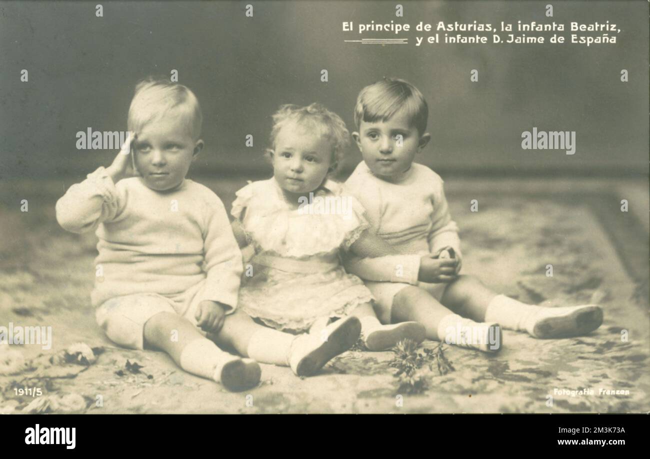 Photographic postcard showing the three eldest children of King Alfonso XIII (1886-1941) and Queen Ena of Spain (1887-1969). From left is Alfonsito, Prince of the Asturias (1907-1938), in the middle the Infanta Beatriz (1909-) and on the right, Infante Jaime (1908-1975). The couple's eldest child suffered from haemophilia, and Infante Jaime was rendered deaf by a childhood illness. One other son was also haemophiliac and eventually it was their grandson, King Juan Carlos, (the offspring of their healthy son, Juan) who came to the throne in 1975 after the death of General Francisco Franco.  c. Stock Photo