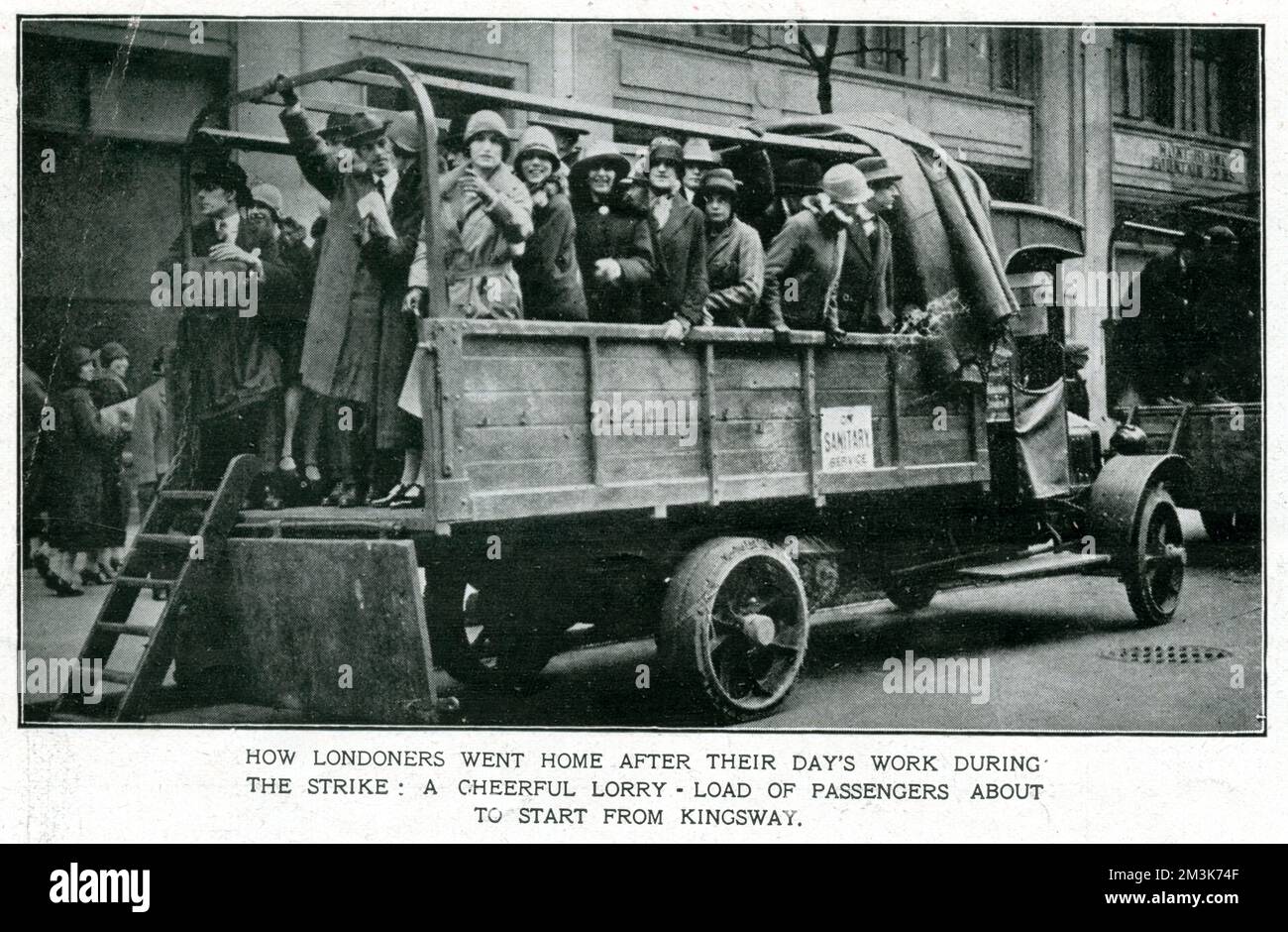 A lorry-load of Londoners in Kingsway, returning home after a day's work during the General Strike.   In support of a strike by coal miners over the issue of threatened wage cuts, the Trades Union Congress called a General Strike in early May 1926. The strike only involved certain key industrial sectors (docks, electricity, gas, railways) but, in the face of well-organised government emergency measures and lack of real public support, it collapsed after nine days.     Date: May 1926 Stock Photo