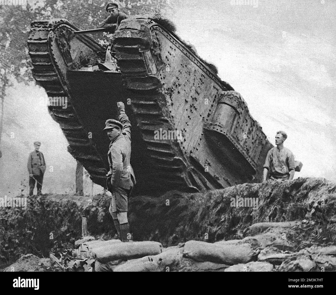 Awaiting the order to advance, with some of its crew outside for a breath of air.    Tanks were first introduced into battle on the 15th September 1916 when a D1 tank was guided into action by Captain H. W. Mortimore at Delville Wood.     Date: 1st December 1917 Stock Photo