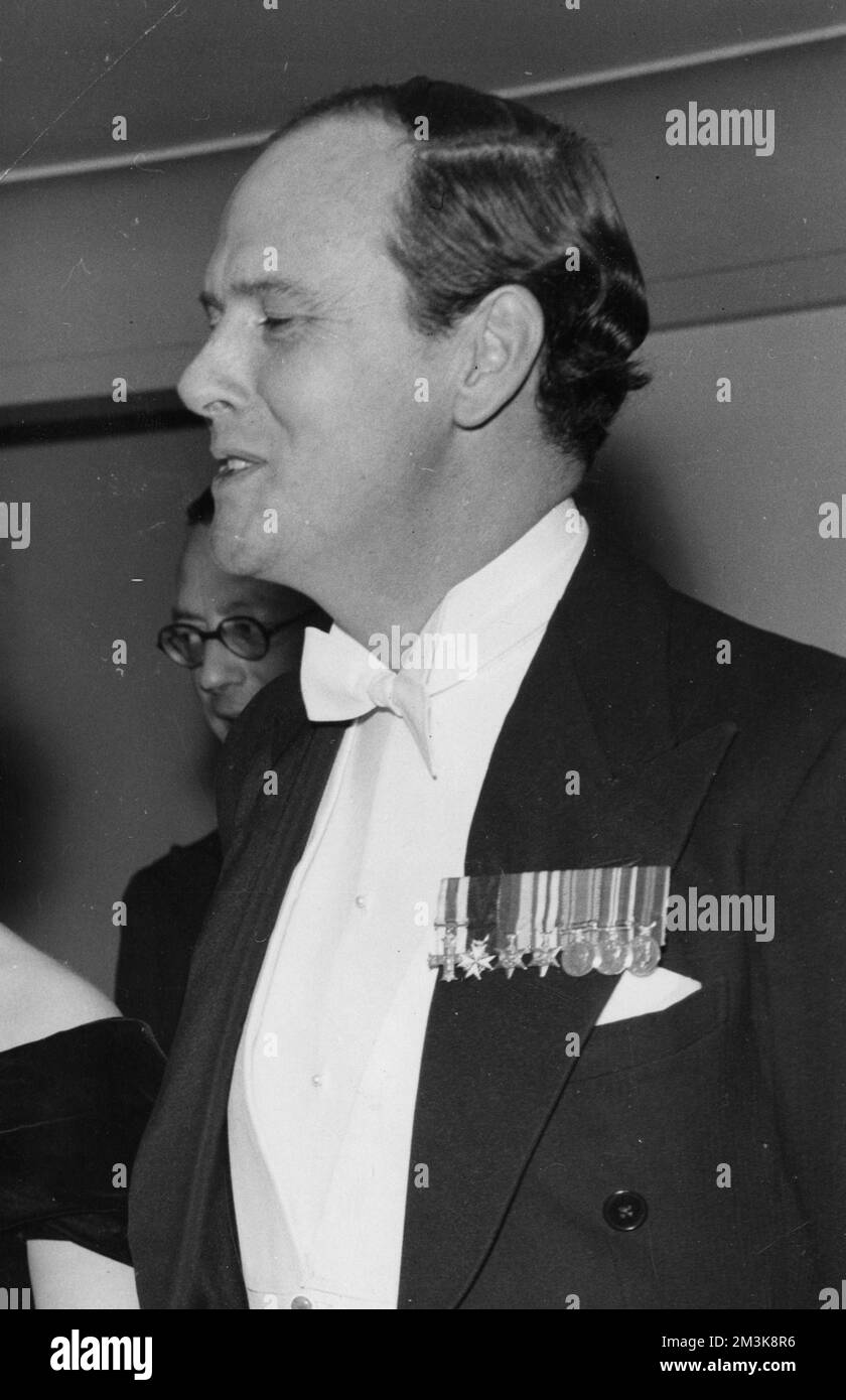 Andrew Robert Buxton Cavendish, 11th Duke of Devonshire (1920-2004), landowner, seen in evening dress and displaying his medals.  Married Deborah Mitford and together were responsible for restoring Chatsworth House to its former glories.     Date: c.1955 Stock Photo