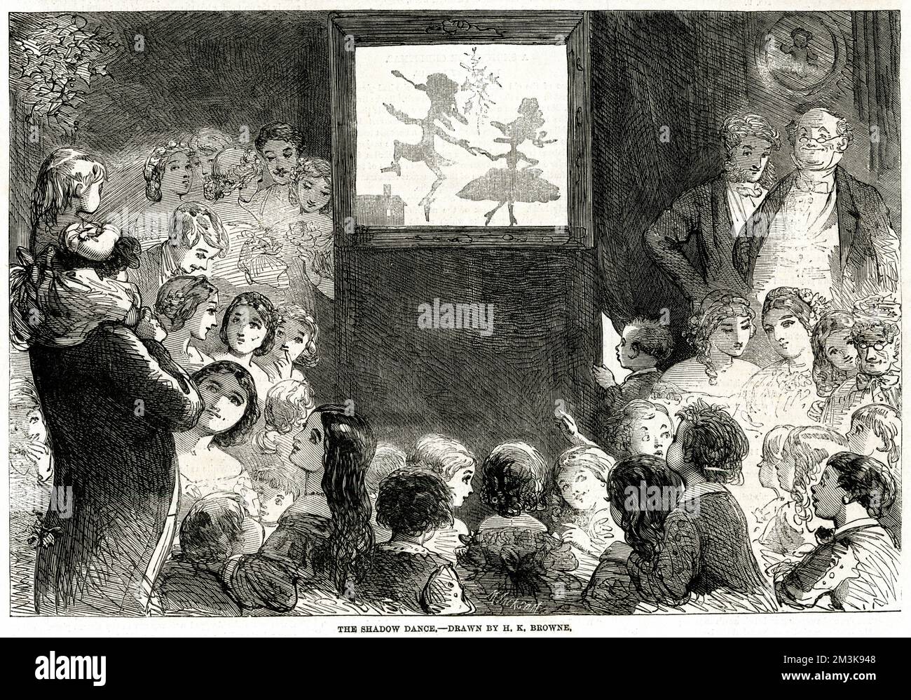 Christmas season, Victorian children being amused by the shadow theatre. Magic lanterns are at hand and many over apparatus profuse of grotesque figures that appear and vanish causing intense amazement and provoking obstreperous mirth.      Date: 1861 Stock Photo