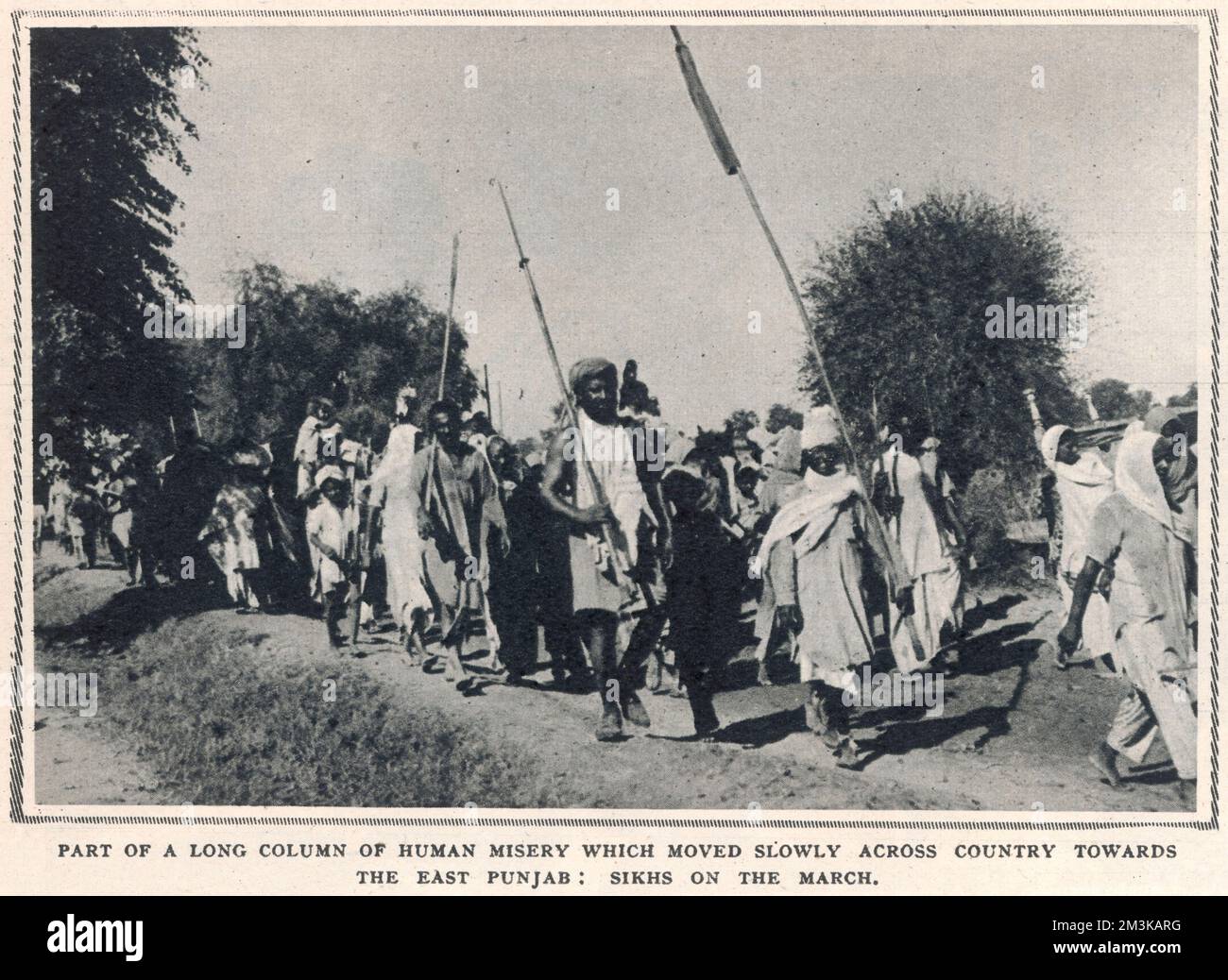 Part of a long column of refugee Sikhs marching across the East Punjab to escape the sectarian religious violence sparked by the partition of India  1947 Stock Photo