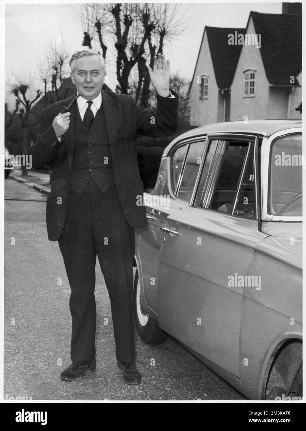 James Harold Wilson (1916-1995), Baron Wilson of Rievaulx, British Labour Prime Minister.  Party leader from 1963.  Prime Minister for two terms - from 1964-1970 and 1974-1976.  Pictured with his famous pipe while leader of the opposition, outside his home in Hampstead Garden Suburb following significant Labour gains during the Greater London Council elections of 1964.     Date: 1964 Stock Photo