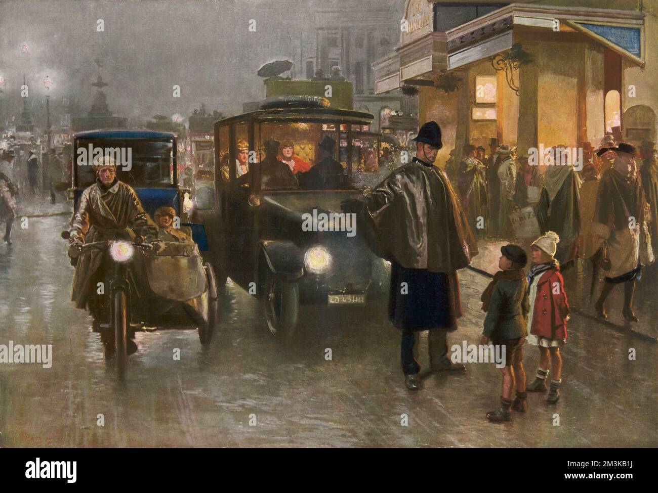 In the centre of London, close to Piccadilly Circus, two children stop a policeman from directing traffic to ask him where Father Christmas is.  The streets are cold and wet and and the inhabitants of cars and taxi cabs can be seen with the statue of Eros visible in the distance.  1921 Stock Photo