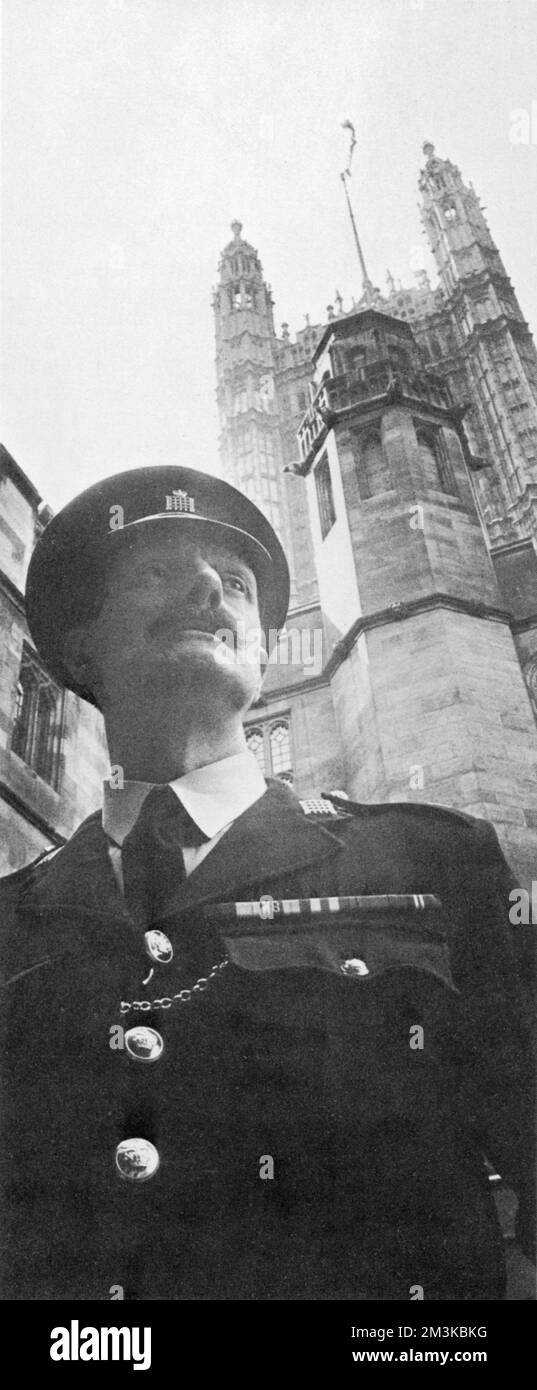 On guard beneath the Victoria Tower is the custodian, Ronald Foyle. Parliamentary custodians supplement the security of the Palace of Westminster; they were formed in 1932 following the Geddes Parliamentary Report which drastically cut the number of regular police assigned to Parliament.      Date: 15th April 1967 Stock Photo