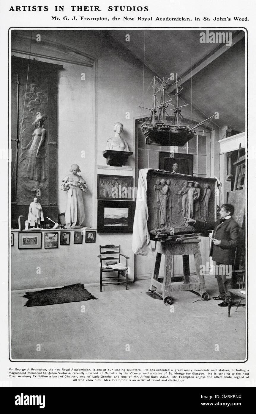 Sir George James Frampton RA (1860 - 1928), sculptor and craftsman, pictured in his studio in St. John's Wood, North London, surrounded by sculptures and pointing at a relief.   A consistently successful sculptor, Frampton is perhaps best known for his Peter Pan sculpture in Kensington Gardens. Stock Photo