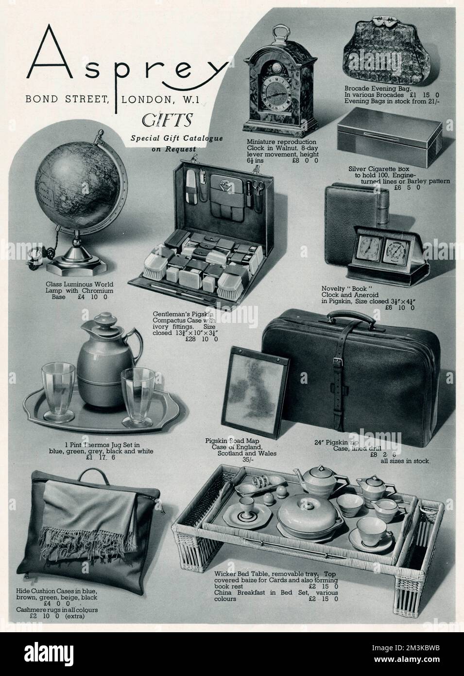 Selection of items from Asprey, Bond Street: Glass luminous World lamp, gentleman's pigskin compactus case with ivory fittings, miniature reproduction clock in walnut, brocade evening bag, pint thrermos jug set, pigskin road map case, pigskin zip luggage case, hide cushion cases and wicker bed table.     Date: 1937 Stock Photo