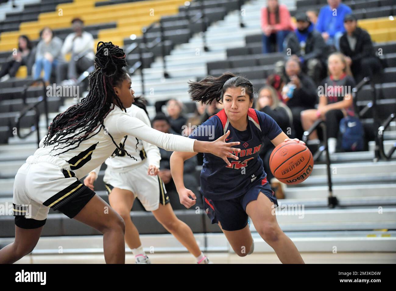 USA. Guard driving the baseline toward the basket while working to get past an opponent. Stock Photo