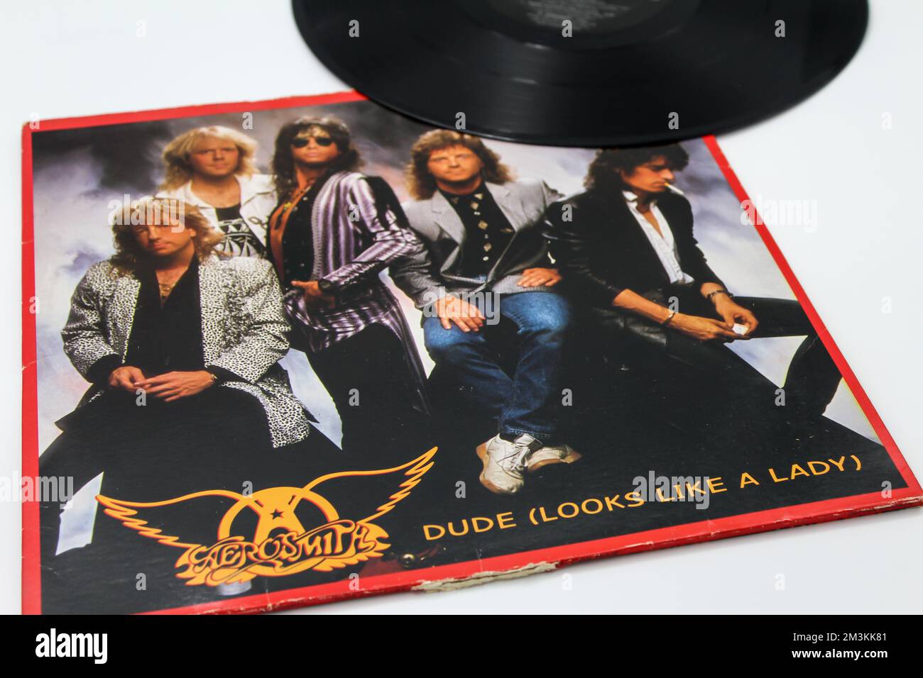 Focus on album title. Classic rock band, Aerosmith, music album on vinyl record LP disc. Titled Dude looks like a lady single Album Cover Stock Photo