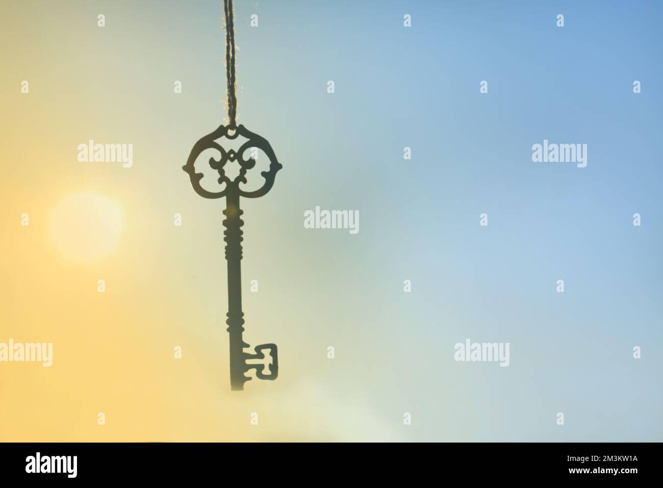 Key on a blurred yellow blue background.Riddle and answer concept.keys