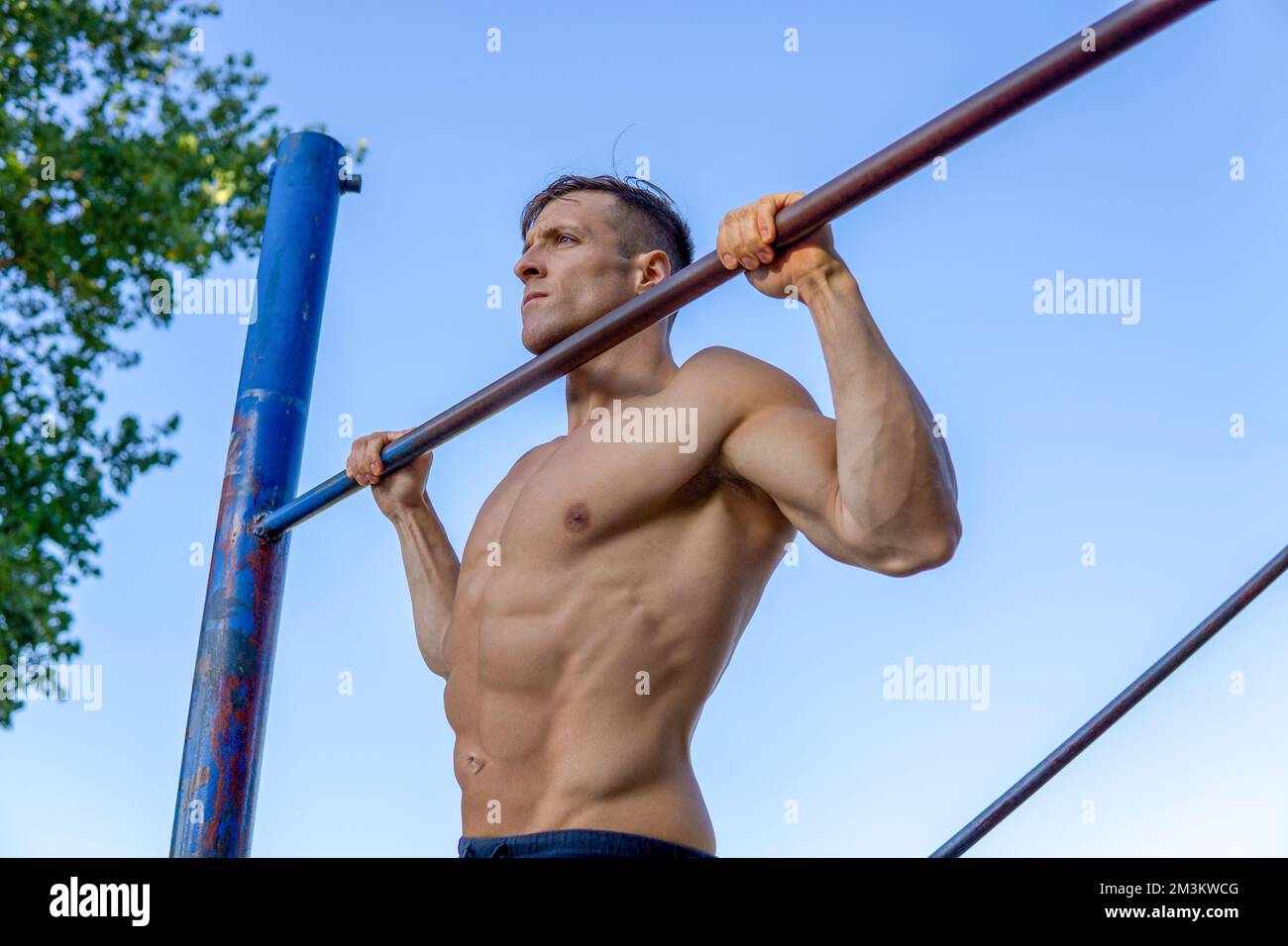 A muscular Caucasian man workout pull ups at outdoor Stock Photo - Alamy