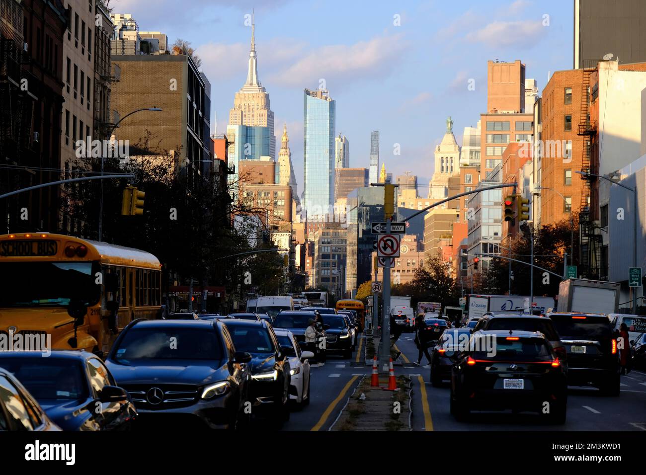 Bowery street during afternoon rush hour with Empire State Building and skyline of Midtown in the background.Manhattan.New York City.USA Stock Photo