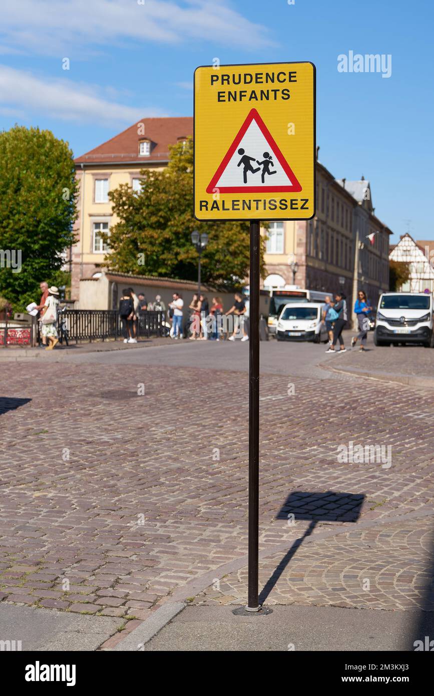 Sign in Colmar in France with the inscription Prudence Entfants Ralentissez. Translation: caution children, drive slowly Stock Photo