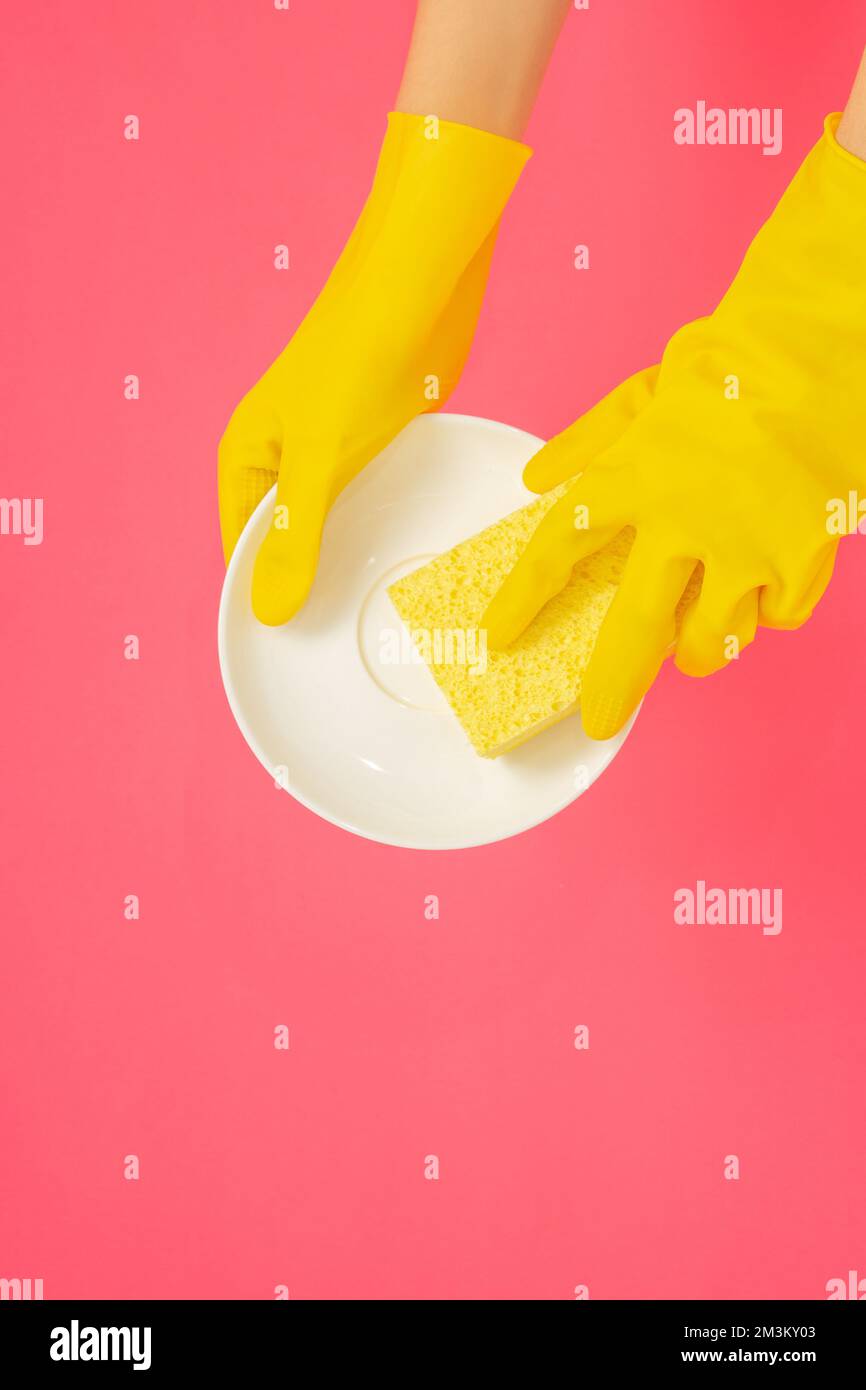 Dishwashing concept, Hands in rubber gloves to holding yellow sponge