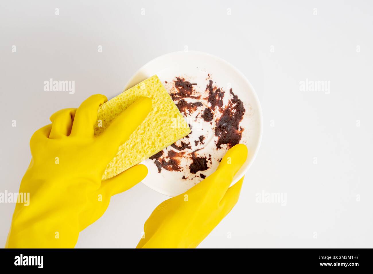 Dishwashing concept, Hands in rubber gloves to holding yellow sponge