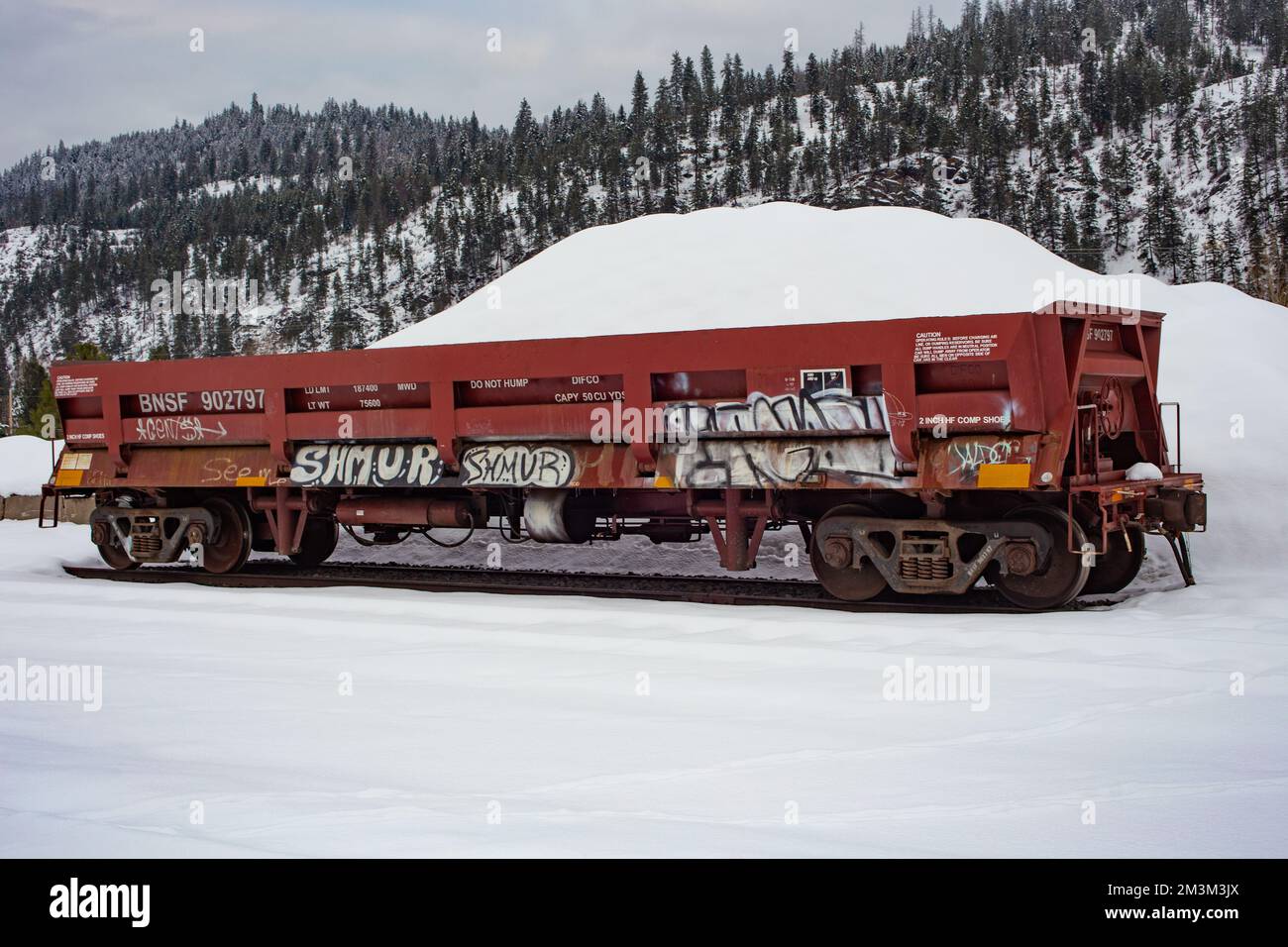 A railroad dump car on the tracks at the BNSF train yard, in the town