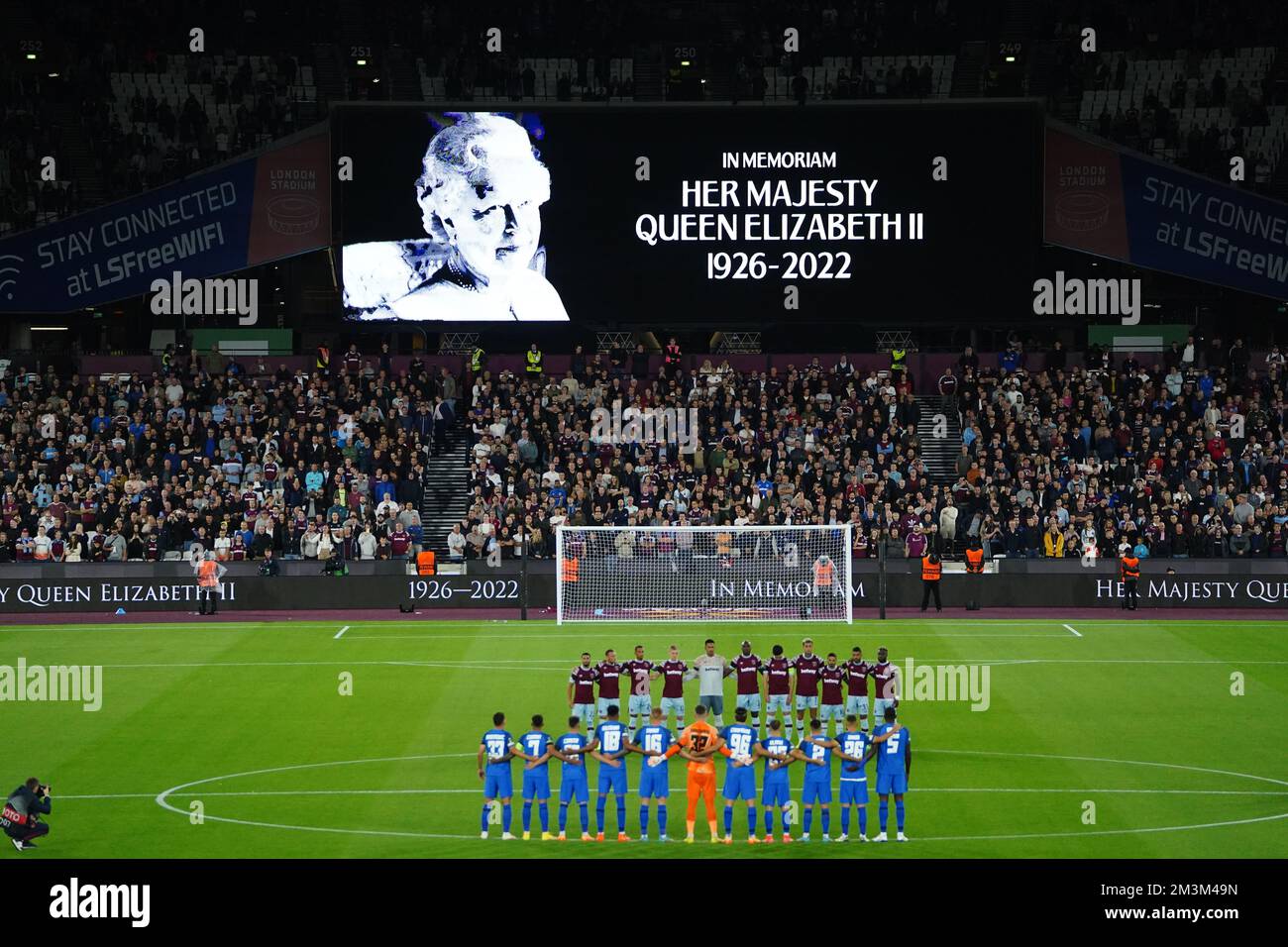 File photo dated 8-09-2022 of The players line up as the big screen displays a message in memoriam following the announcement of the death of Queen Elizabeth II, before the UEFA Europa Conference League Group B match between West Ham United and FCSB at the London Stadium, London. Horse racing, cricket, football, rugby union and golf action on Friday was called off as a mark of respect after the Queen died at the age of 96. Issue date: Friday December 16, 2022. Stock Photo