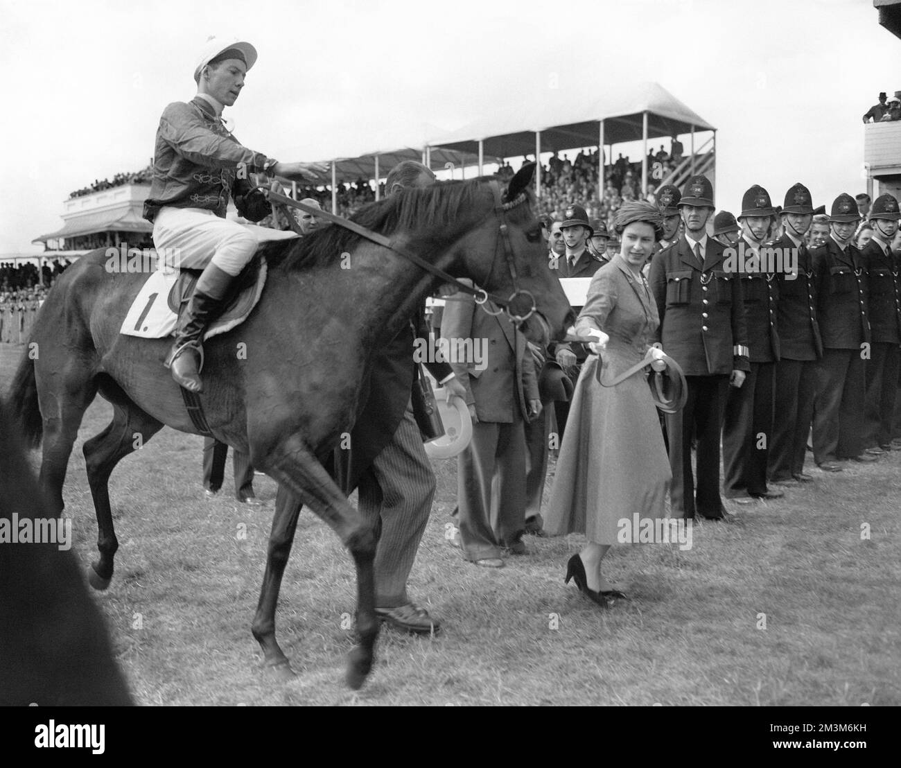 File photo dated 07-10-1957 of The Queen leading her Oaks winner filly Carrozza, with Lester Piggott. Unquestionably one of the greatest jockeys of all time, Piggott's Classic haul included nine Derby victories and he was crowned champion jockey on 11 occasions. It was in 1954 aboard Never Say Die he clinched his first Derby win. Eight years later and 1966 proved his best season with 191 winners. He died at the age of 86. Issue date: Friday December 16, 2022. Stock Photo