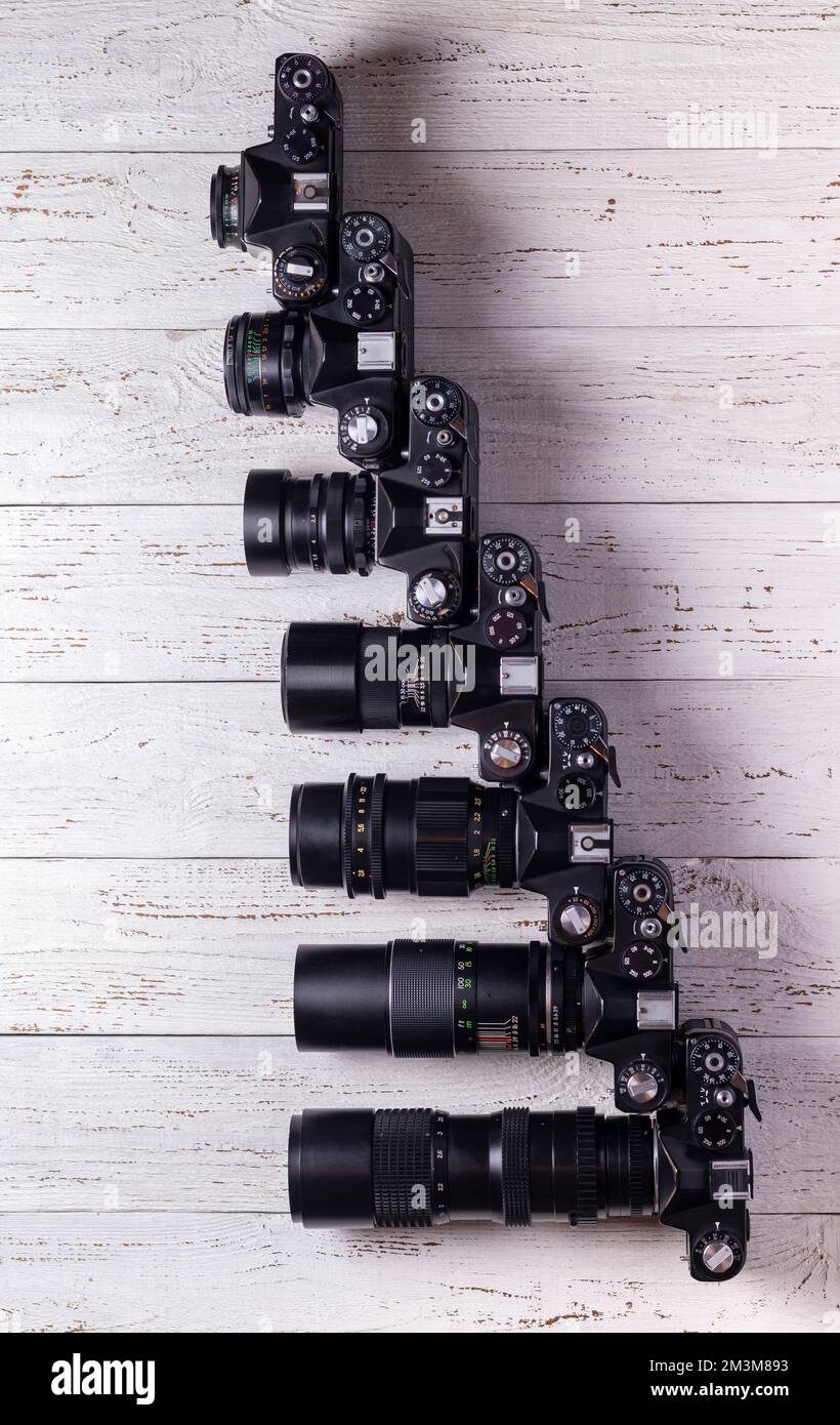 Old retro cameras with different lenses in size. View from above. Stock Photo