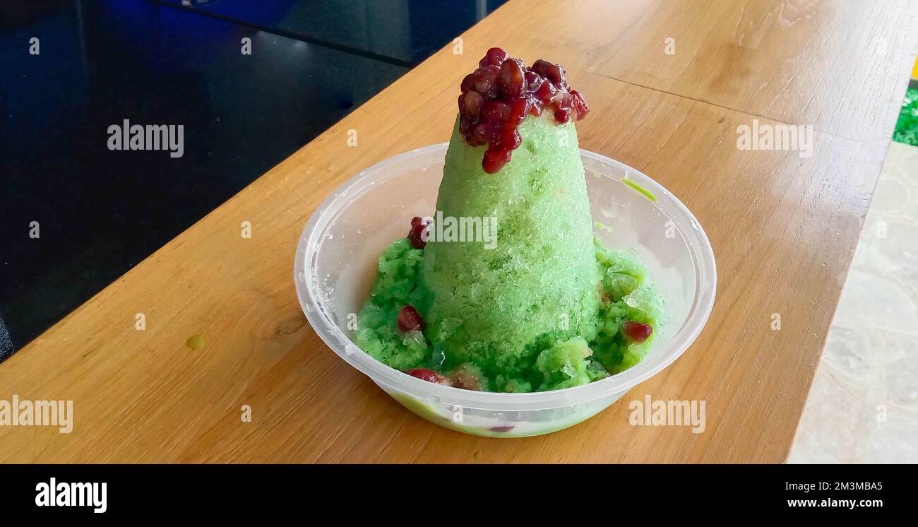 kakigori is Japanese shaved ice dessert , with red beans and sweet sauce on ice cream. Traditional summer dessert in Japan Stock Photo