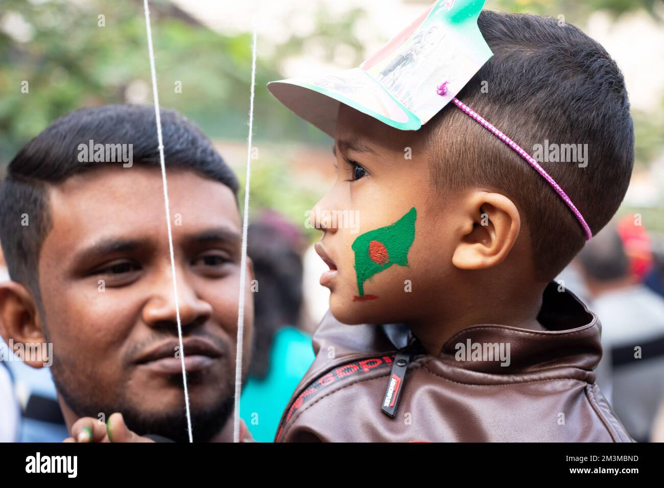 Narayanganj, Dhaka, Bangladesh. 16th Dec, 2022. A Bangladeshi child with a national flag painted on the face to celebrate the 52nd Victory Day, which marks the end of a bitter nine-month war of independence from Pakistan, in Narayanganj, Bangladesh. Bangladesh is celebrating the 52nd anniversary of its national victory, remembering the valiant freedom fighters who fought and made the ultimate sacrifice to free the country from the Pakistani forces. People from all walks of life gather at the Narayanganj Central Shaheed Minar in the morning to mark the most precious day of the Bangali people Cr Stock Photo