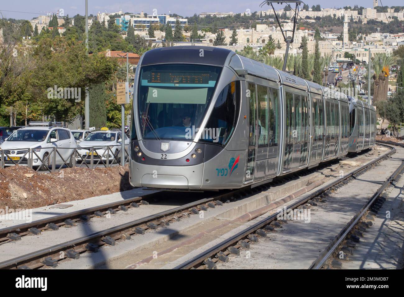 11 Nov 2022 A very modern tram of the Harakevet Hakala;, Jerusalem tram network, climbs the hill in Jaffa Street as it passes the Jaffa Gate of the an Stock Photo
