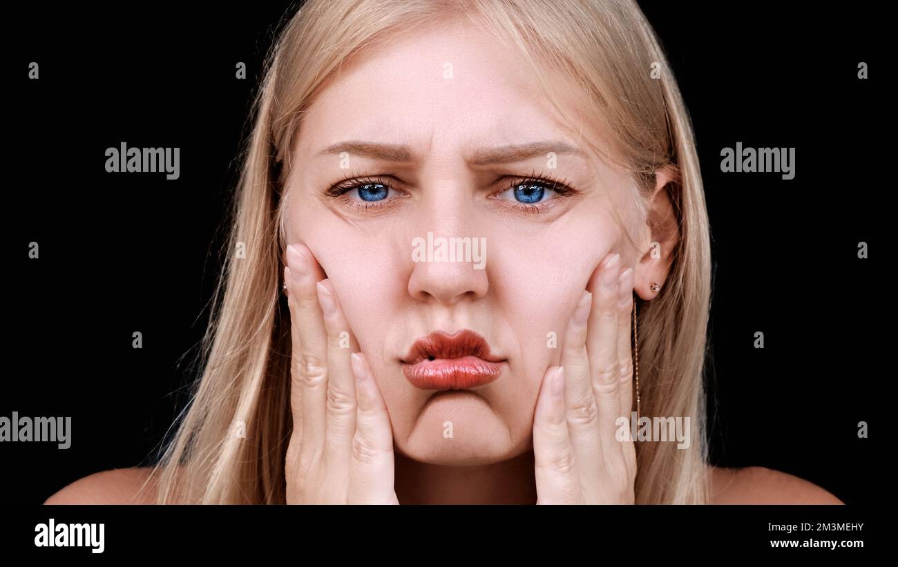 Second chin, obesity. Portrait of a 30yearold woman pulling back the