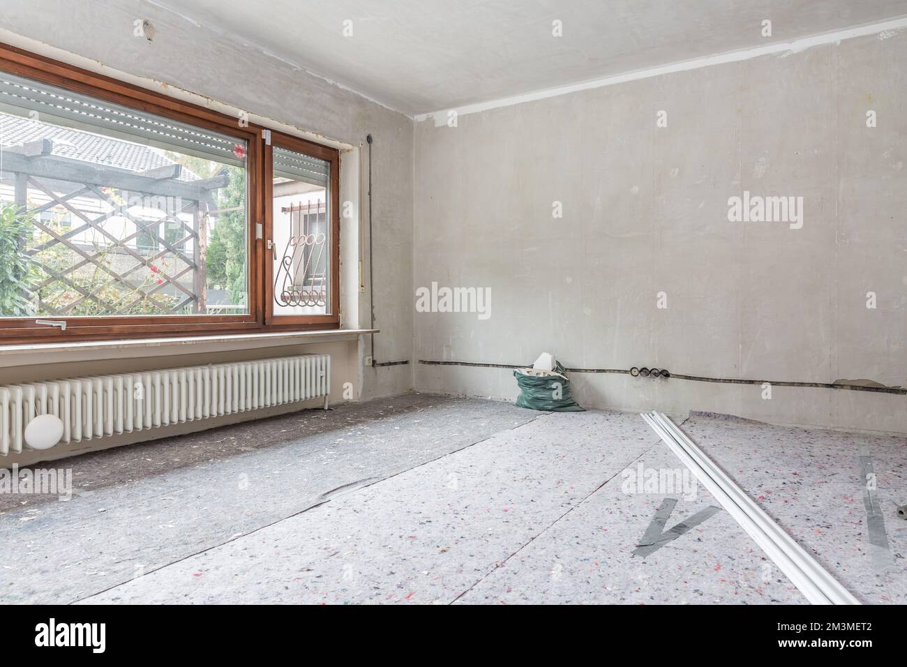Renovation of old house, room under construction with unpainted walls, old window Stock Photo