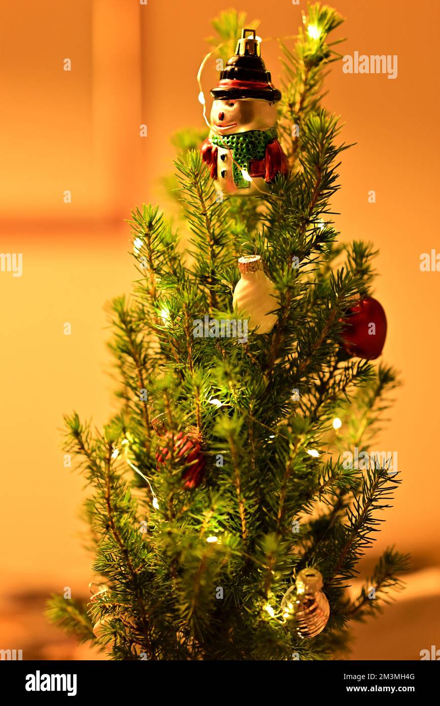 Miniature christmas tree decorated with bullets and a figure Stock Photo