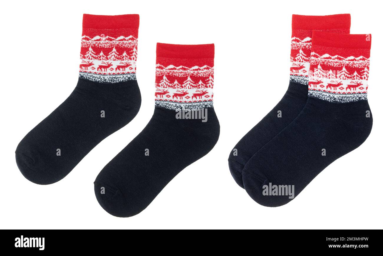 Pair of red nordic socks with bear and snowflake geometric ornament isolated on a white background Stock Photo