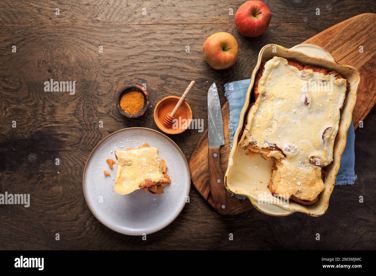 Homemade bread pudding breakfast casserole with apples and cinnamon and egg white frosting Stock