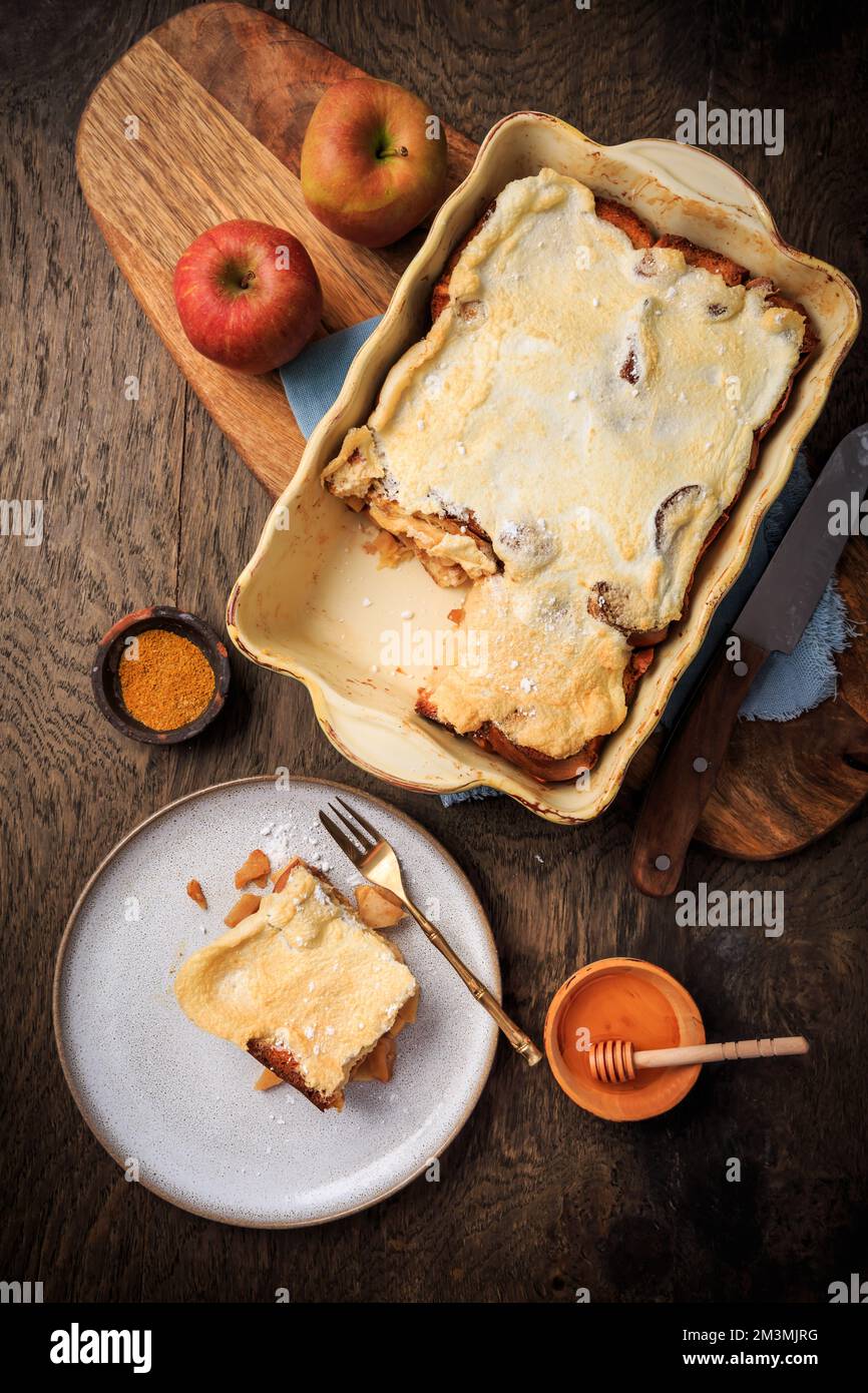 Homemade bread pudding breakfast casserole with apples and cinnamon and egg white frosting Stock