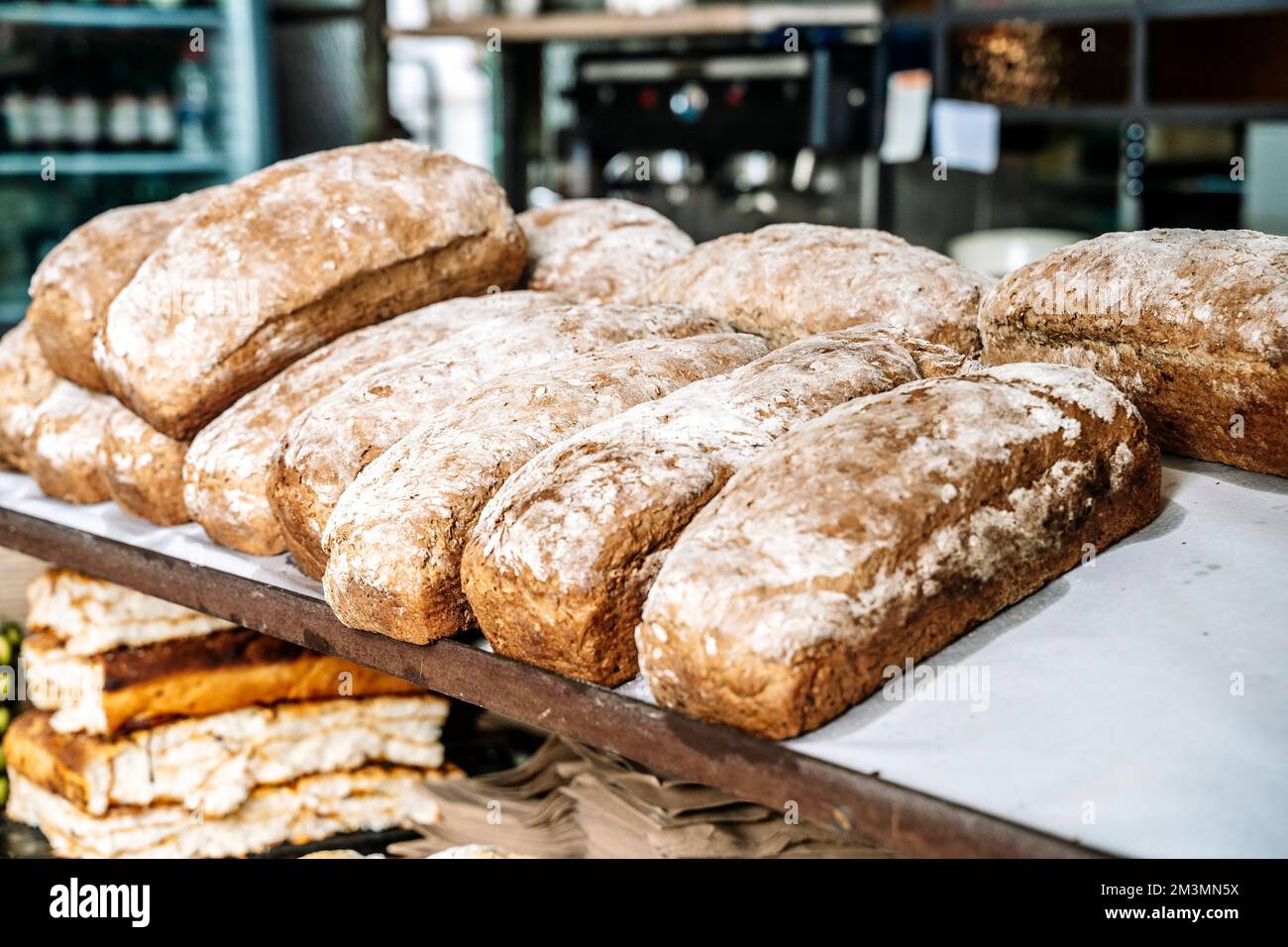 Loaves of bread on the shelves of the shop bakery counter. Fresh, homemade wheat and whole grain breads and pastries. High quality photo Stock Photo