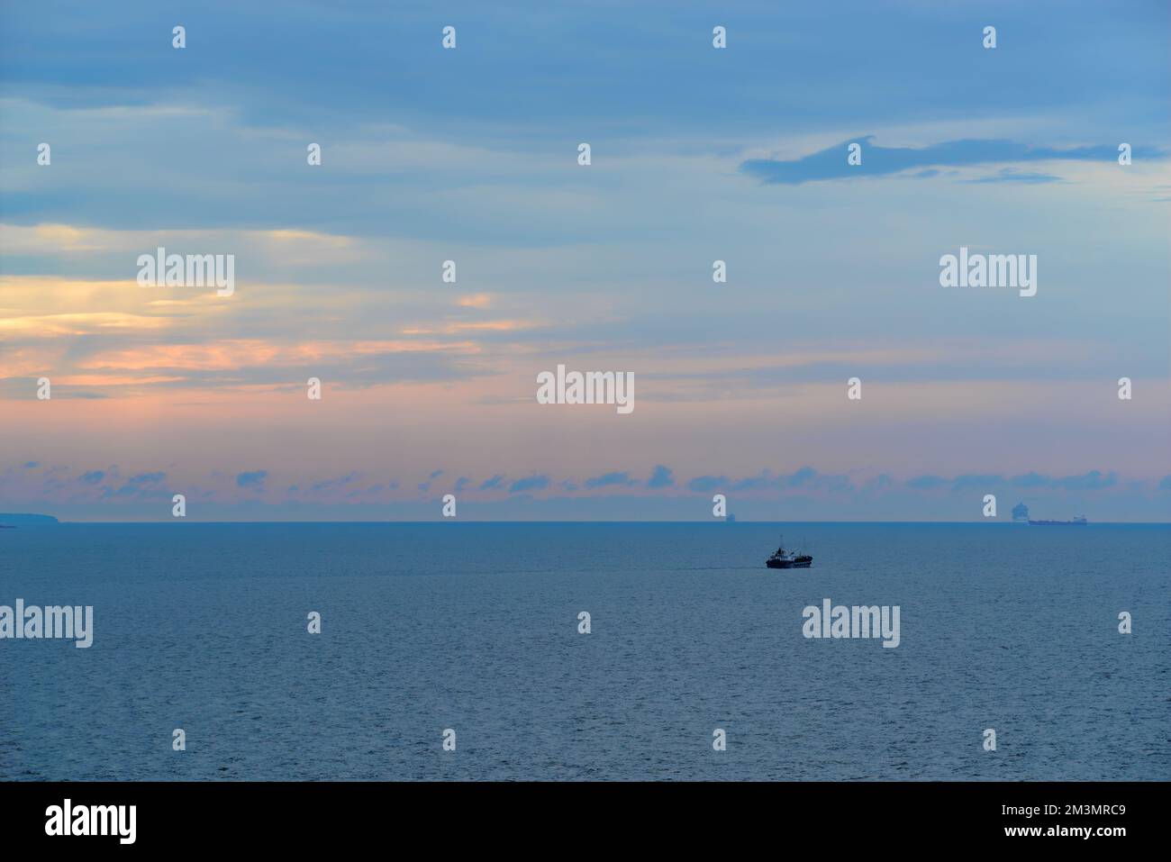 Panoramic view of sea and ship against horizon over water Stock Photo