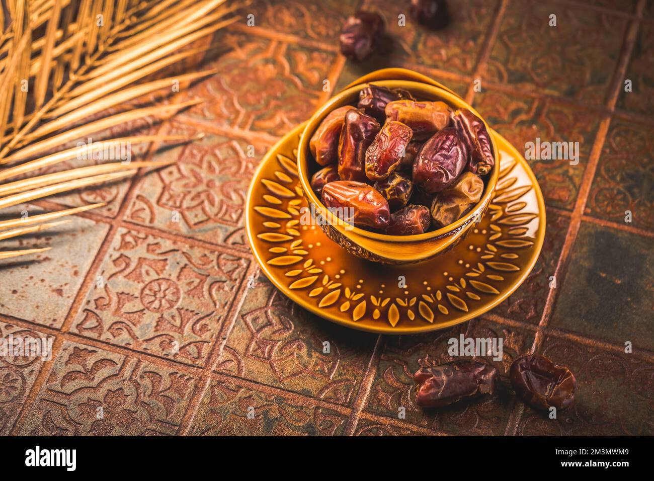 Dried  organic dates in bowl on old kitchen table Stock Photo