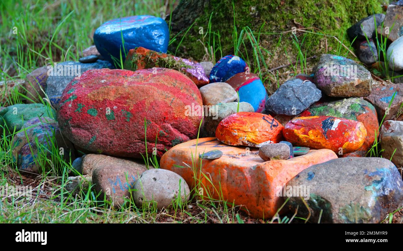 Colorful stones at the foot of a tree. Seen in a wood in Itterbeck, Germany Stock Photo