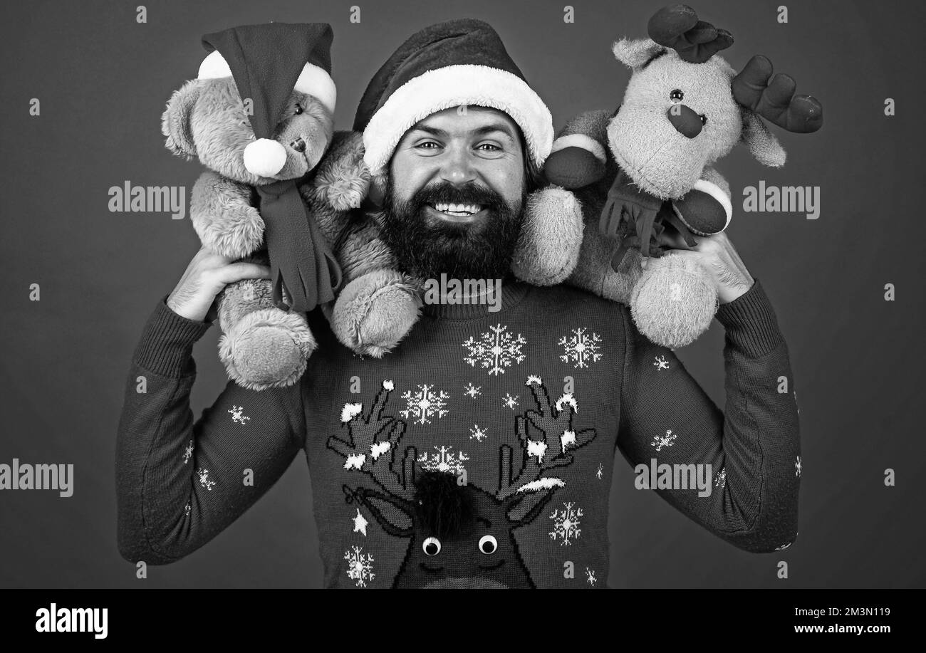 happy bearded man in santa claus costume celebrate winter holiday of chistmas and feel merry about xmas gifts, toy shop Stock Photo