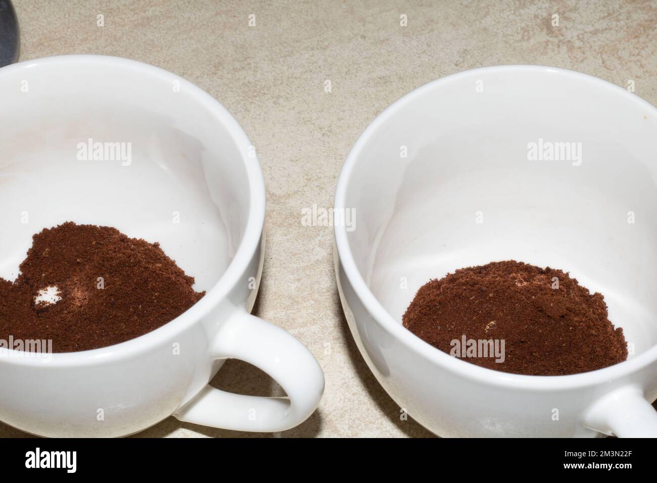 photo of ground coffee in two white cups on the table Stock Photo