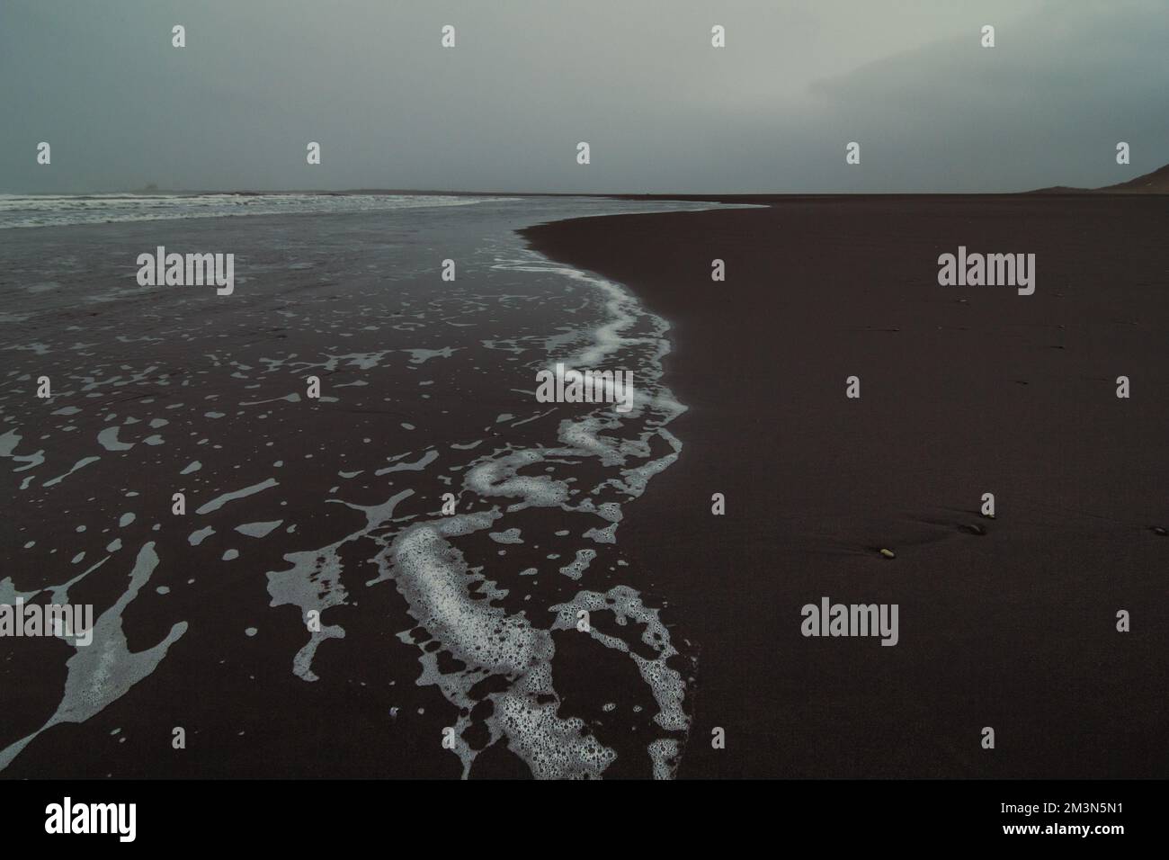 Wet surfline of black beach landscape photo Stock Photo